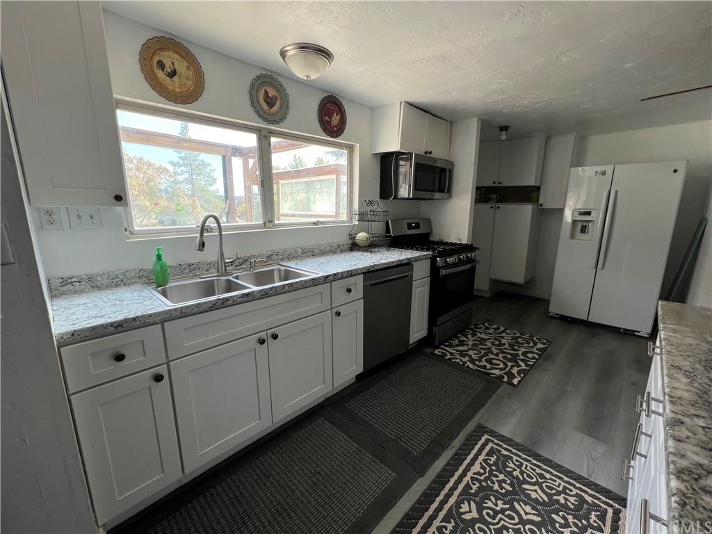 39311 Howard Road Anza, CA 92539 - Photo 5 of 23 a kitchen with stainless steel appliances a refrigerator a sink a stove a microwave and cabinets