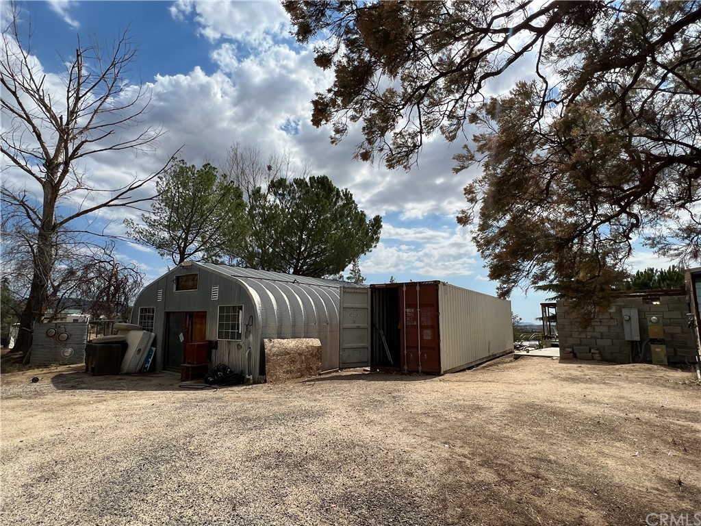 39311 Howard Road Anza, CA 92539 - Photo 8 of 23 a front view of a house with a yard and garage