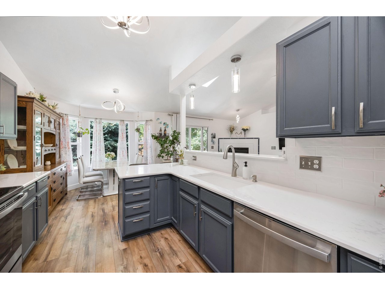 148 Beacon Way Windsor, CO 80550 - Photo 13 of 36 Spacious kitchen with extended counter space, subway tile backsplash, stainless steel dishwasher, undermount sink with updated fixturesand, and seamless flow into the dining and living areas.
