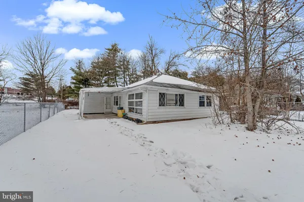 a yellow house with trees in front of it