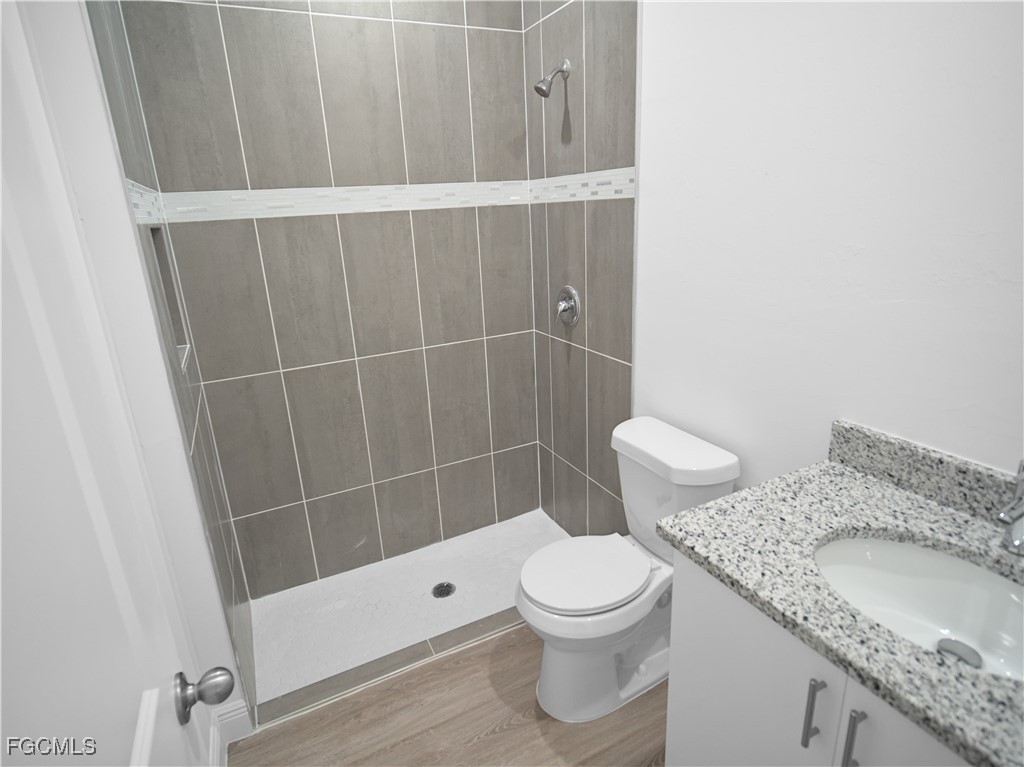 3059 Harvard Circle LaBelle, FL 33935 - Photo 9 of 10 a bathroom with a granite countertop toilet and a sink