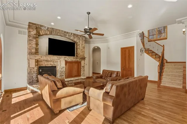 a living room with furniture a flat screen tv and a fireplace