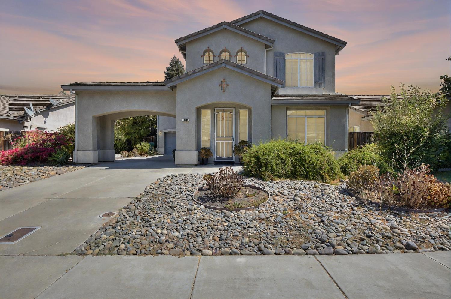 10628 Hidden Grove Circle Stockton, CA 95209 - Photo 1 of 41 a front view of a house with a yard
