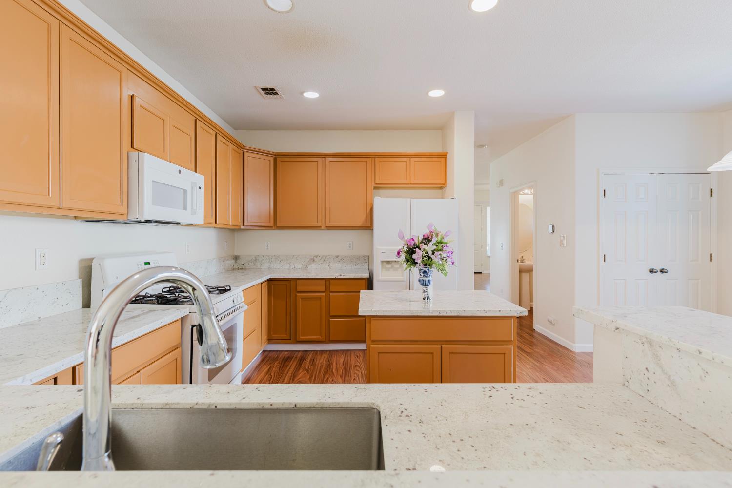 10628 Hidden Grove Circle Stockton, CA 95209 - Photo 13 of 41 a kitchen with stainless steel appliances granite countertop a sink a stove and a refrigerator