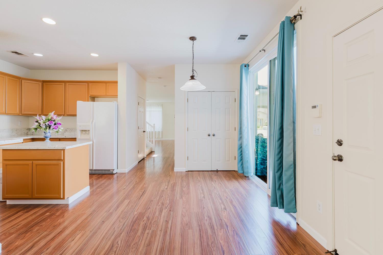 10628 Hidden Grove Circle Stockton, CA 95209 - Photo 14 of 41 a open kitchen with white cabinets and wooden floor