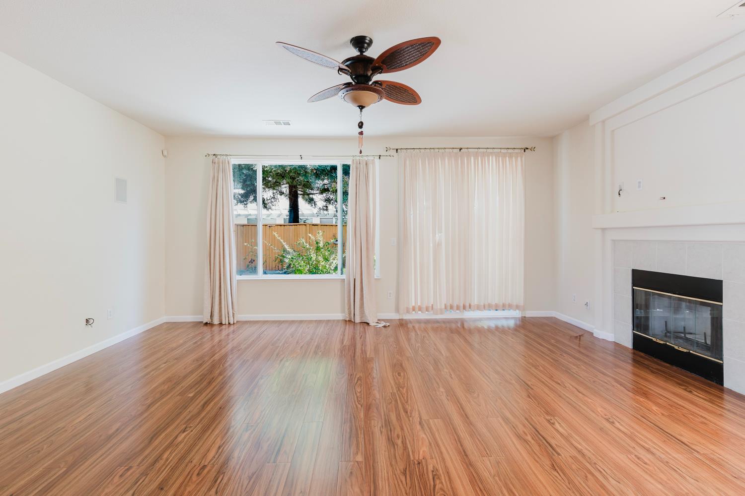 10628 Hidden Grove Circle Stockton, CA 95209 - Photo 15 of 41 wooden floor in an empty room with a window