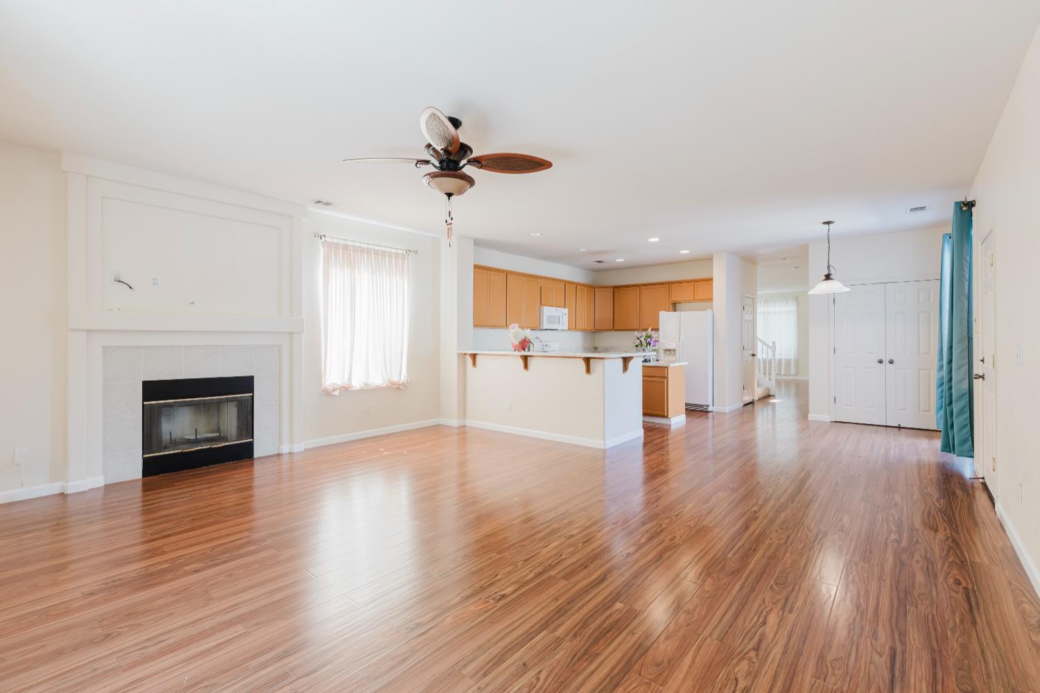 10628 Hidden Grove Circle Stockton, CA 95209 - Photo 16 of 41 a view of a kitchen with wooden floor and a fireplace