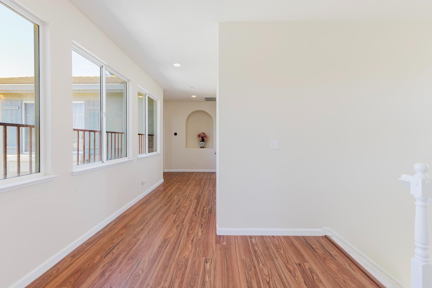 10628 Hidden Grove Circle Stockton, CA 95209 - Photo 18 of 41 a view of a room with wooden floor and windows