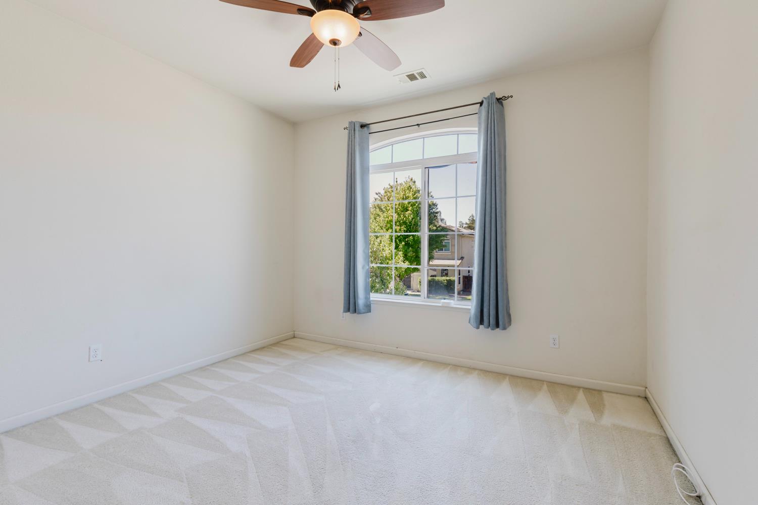 10628 Hidden Grove Circle Stockton, CA 95209 - Photo 21 of 41 an empty room with a window