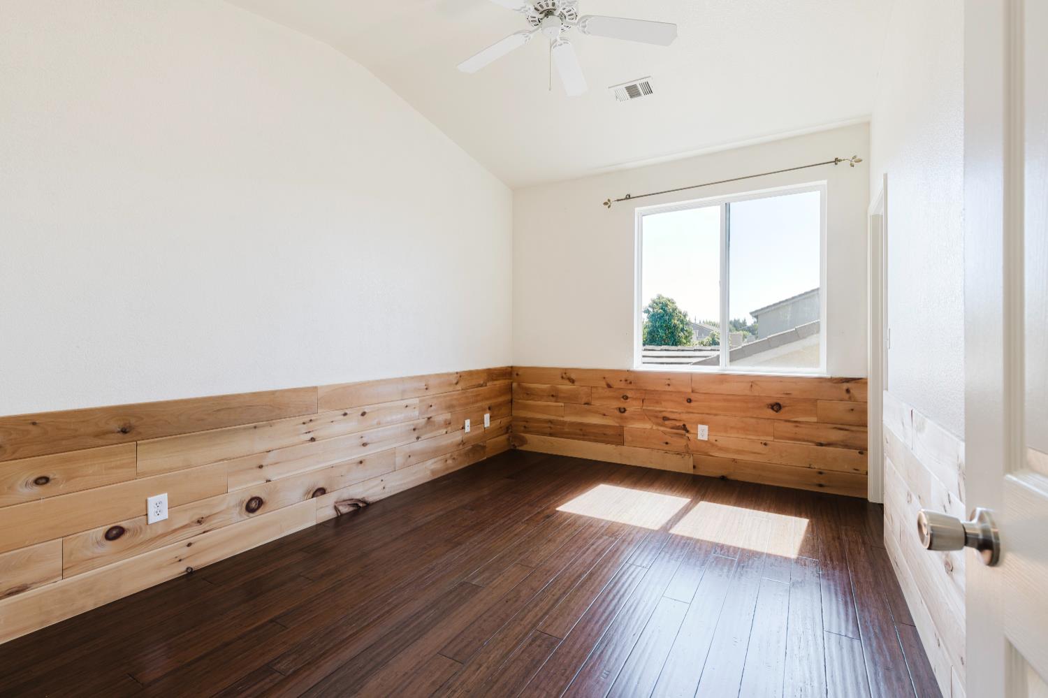 10628 Hidden Grove Circle Stockton, CA 95209 - Photo 25 of 41 a view of an empty room with wooden floor and a window