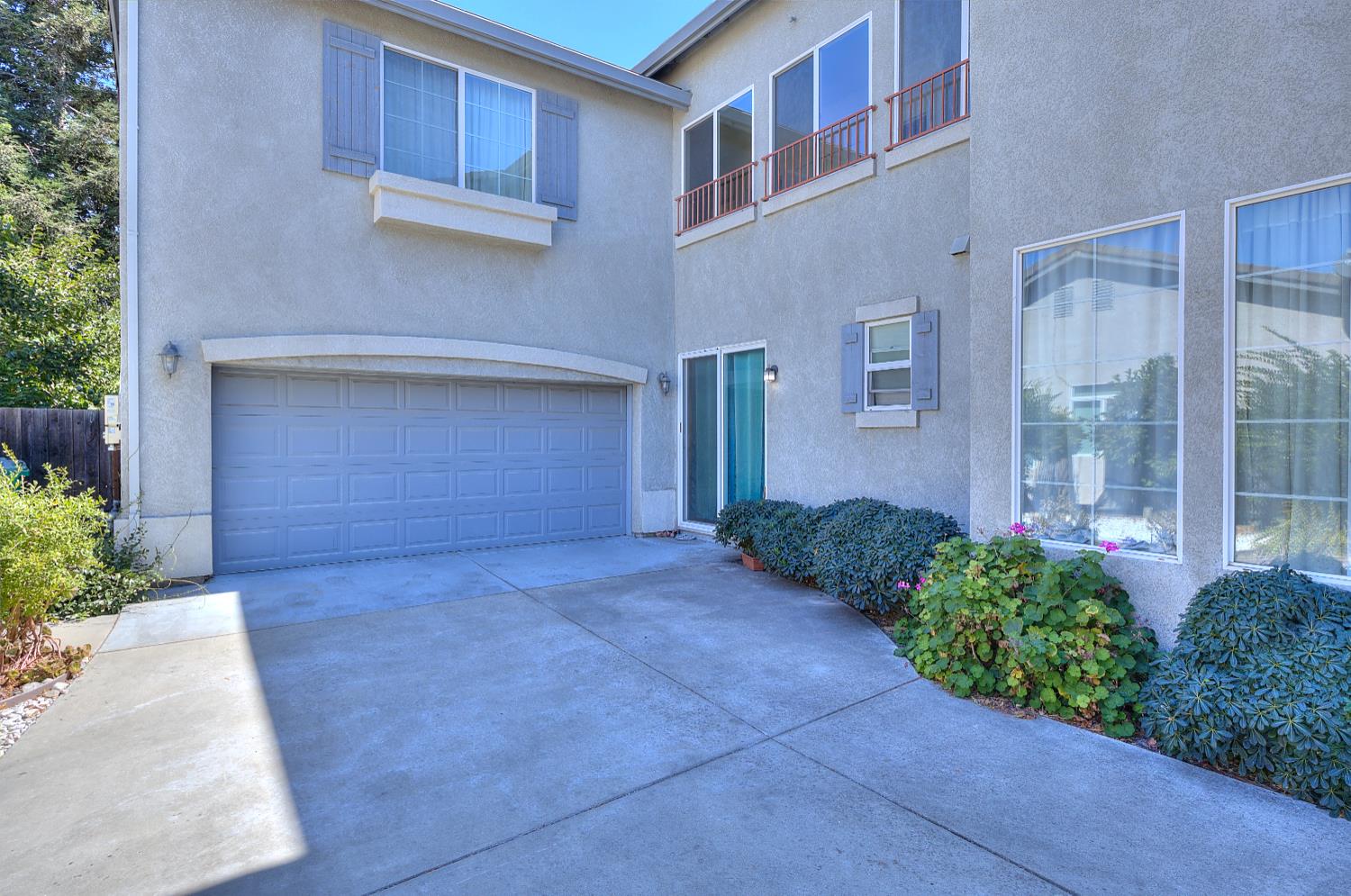 10628 Hidden Grove Circle Stockton, CA 95209 - Photo 3 of 41 a front view of a house with a yard and garage