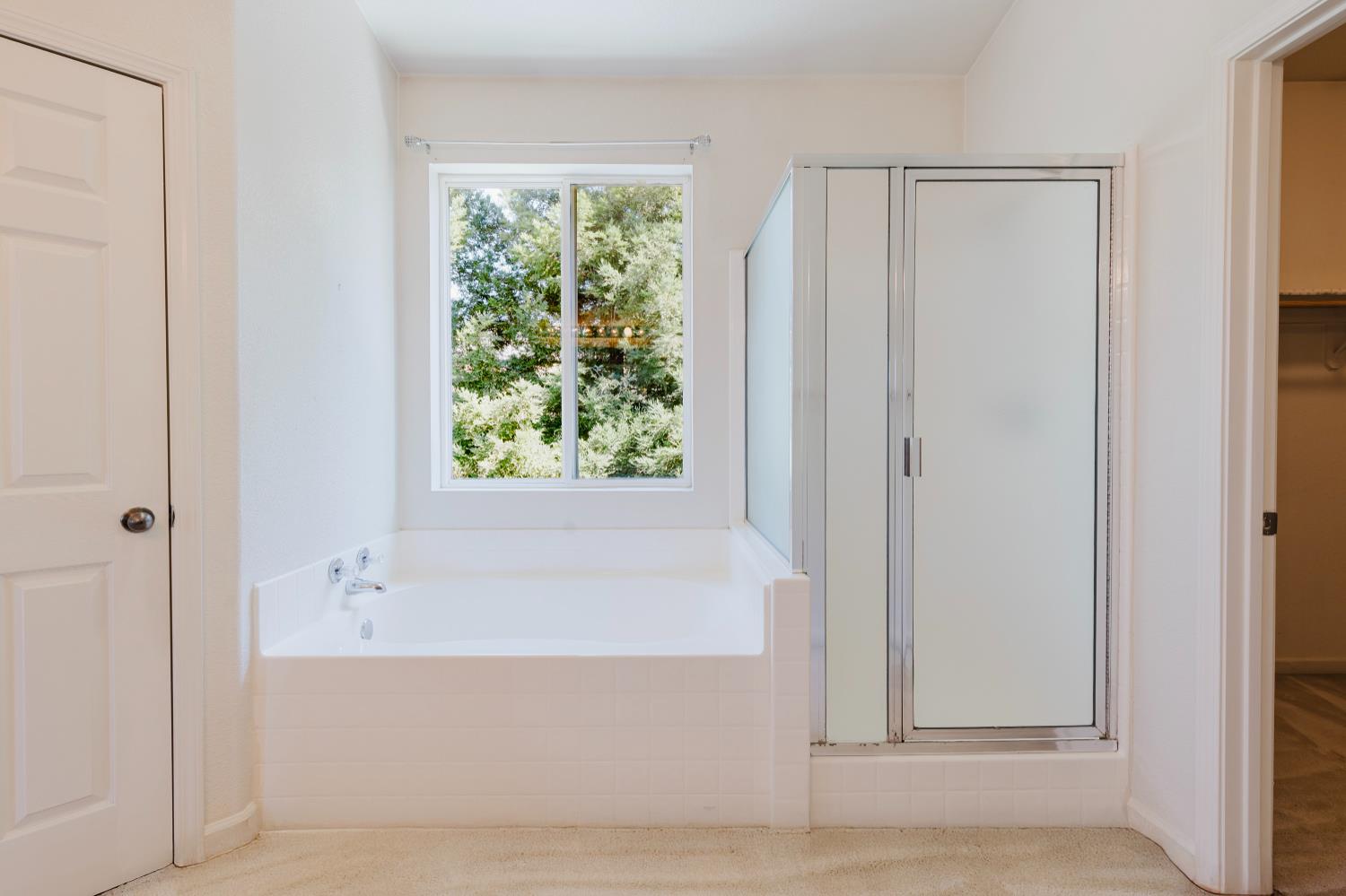 10628 Hidden Grove Circle Stockton, CA 95209 - Photo 32 of 41 a bathroom with a bathtub and shower