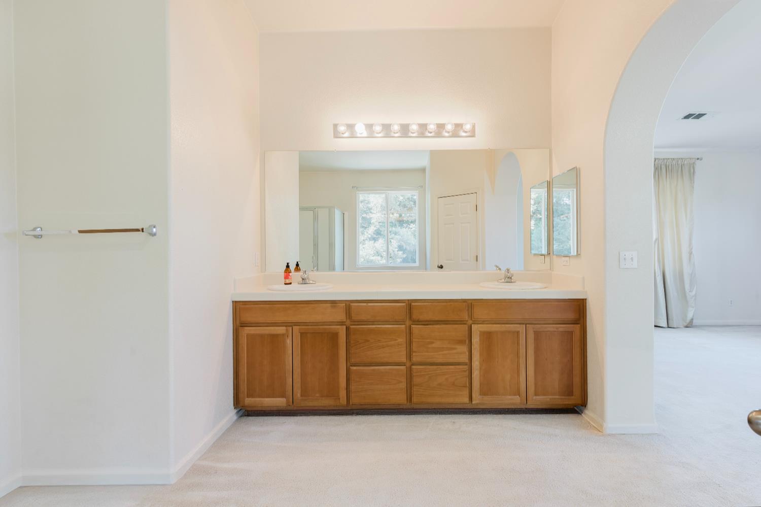 10628 Hidden Grove Circle Stockton, CA 95209 - Photo 33 of 41 a spacious bathroom with a double vanity sink and a mirror
