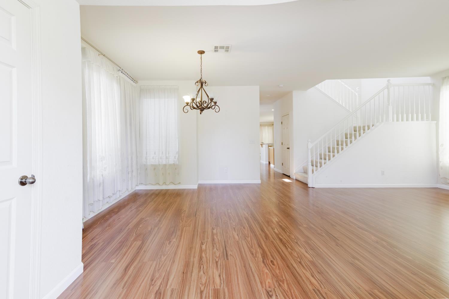 10628 Hidden Grove Circle Stockton, CA 95209 - Photo 4 of 41 a view of an empty room with wooden floor and a window