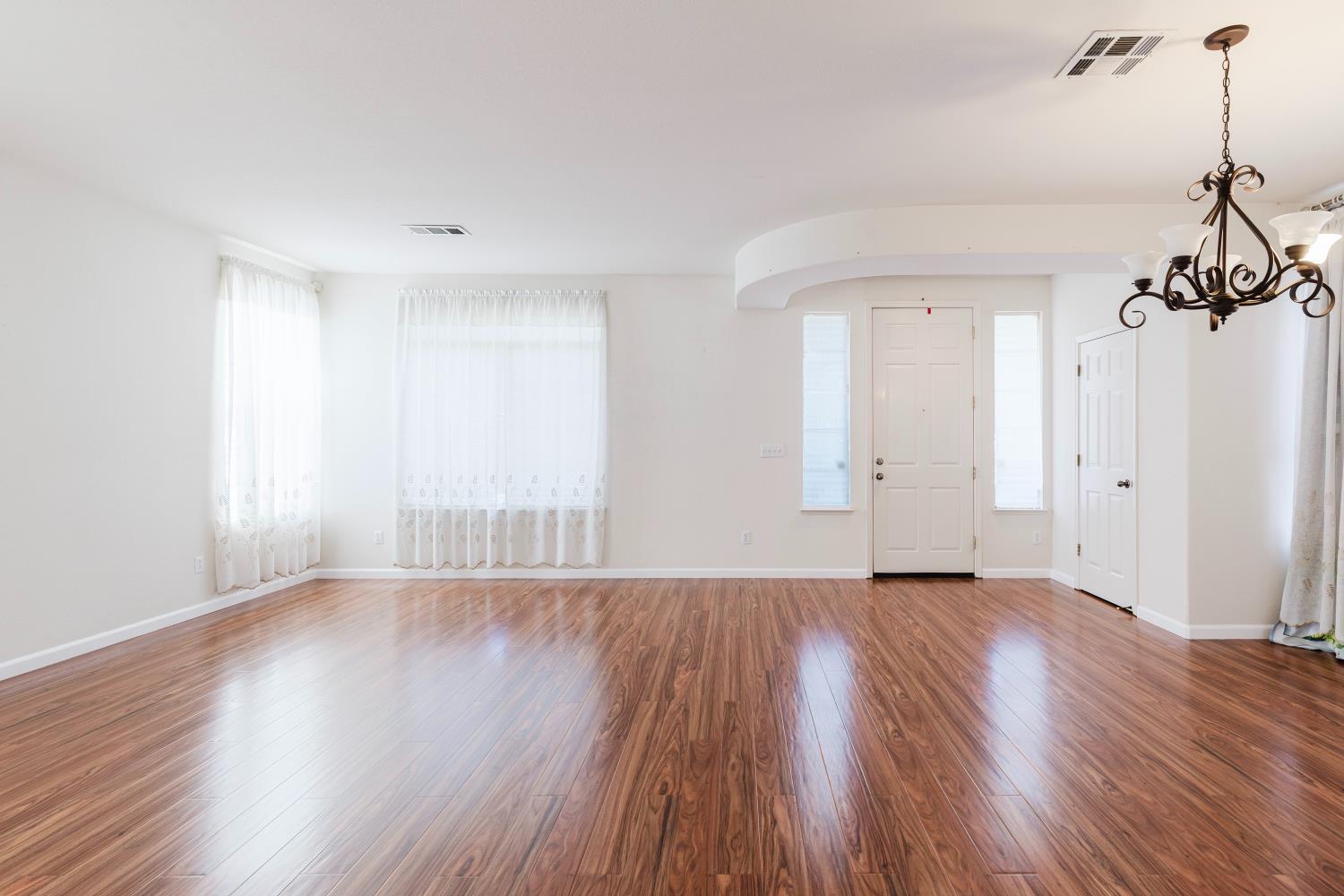 10628 Hidden Grove Circle Stockton, CA 95209 - Photo 7 of 41 wooden floor in an empty room with a window