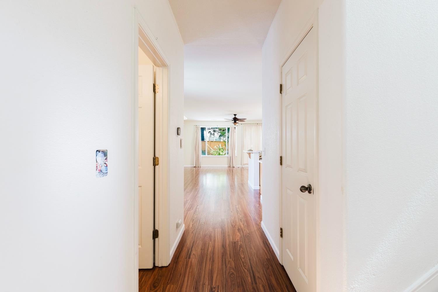 10628 Hidden Grove Circle Stockton, CA 95209 - Photo 9 of 41 a view of a hallway with wooden floor