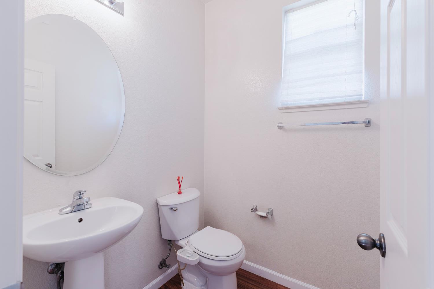 10628 Hidden Grove Circle Stockton, CA 95209 - Photo 10 of 41 a bathroom with a sink a toilet and a mirror