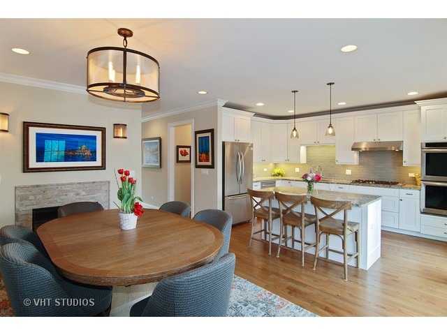 21 North Herbert Road, Unit F Riverside, IL 60546 - Photo 6 of 21 a kitchen with stainless steel appliances kitchen island a dining table and chairs