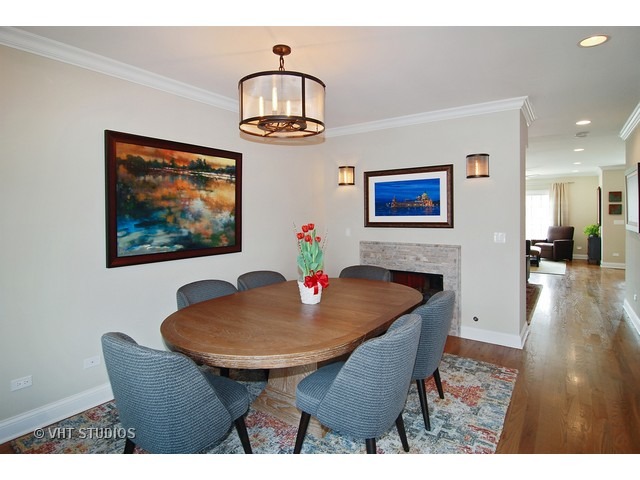 21 North Herbert Road, Unit F Riverside, IL 60546 - Photo 7 of 21 a view of a dining room with furniture wooden floor and a chandelier