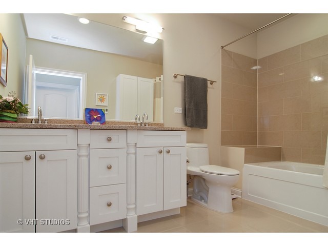 21 North Herbert Road, Unit F Riverside, IL 60546 - Photo 10 of 21 a bathroom with a double vanity sink mirror and toilet