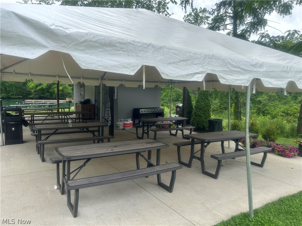 824 South Chillicothe Road, Unit 2 Aurora, OH 44202 - Photo 40 of 42 Paved outdoor patio featuring a white tent structure, multiple picnic tables, and a grill area