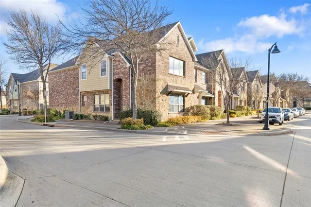 a view of a brick building next to a road