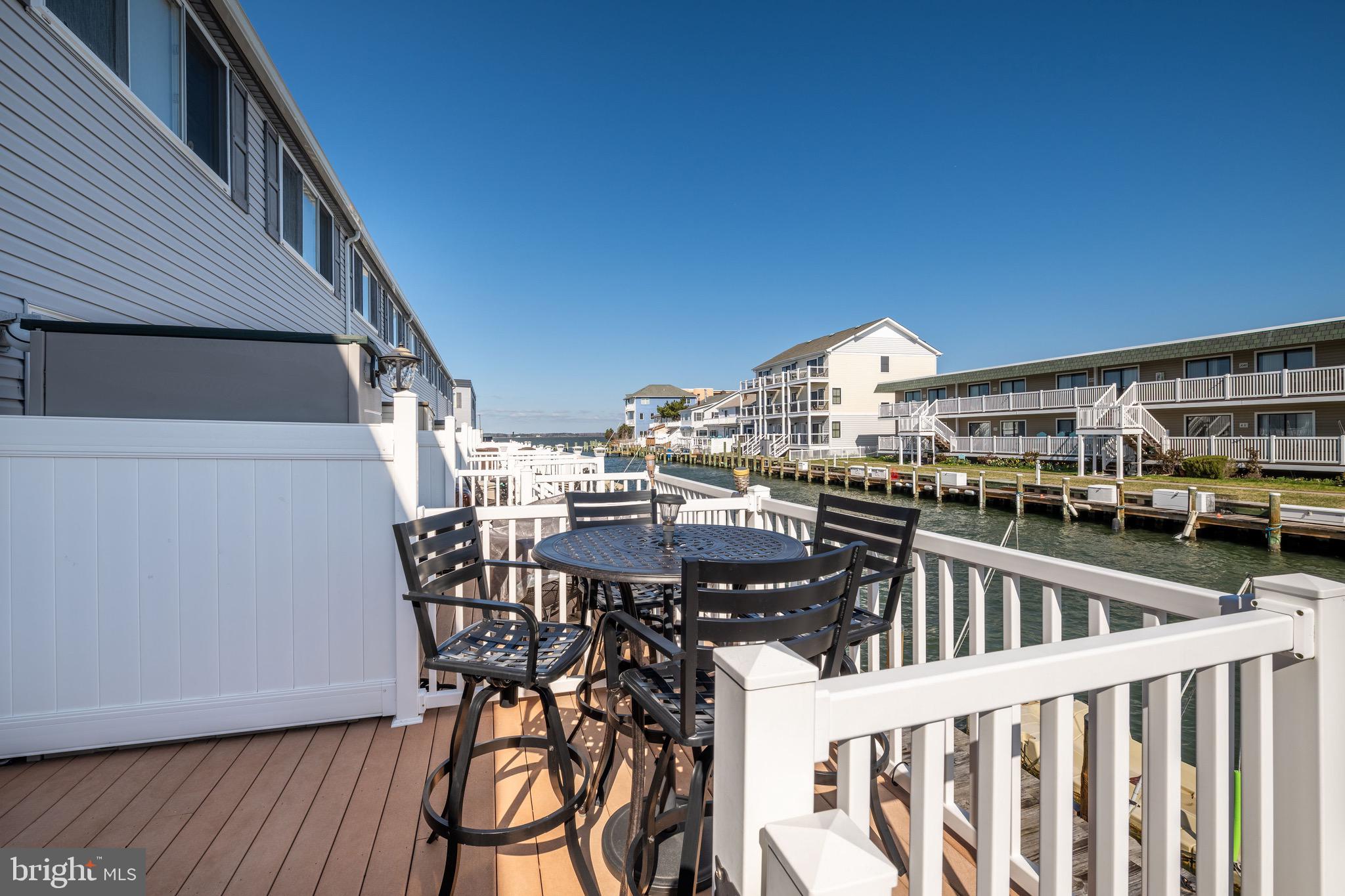 720 Rusty Anchor Road, Unit 41C Ocean City, MD 21842 - Photo 13 of 32 a view of a chairs and table in the roof deck