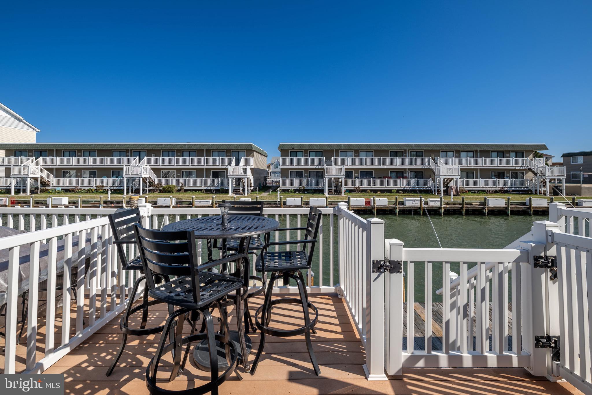 720 Rusty Anchor Road, Unit 41C Ocean City, MD 21842 - Photo 16 of 32 a view of a chairs and table on the terrace