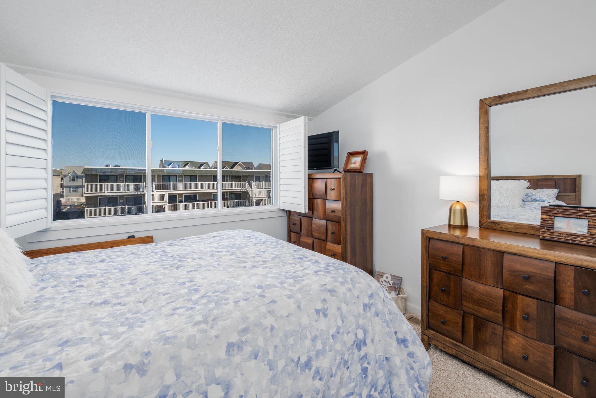 720 Rusty Anchor Road, Unit 41C Ocean City, MD 21842 - Photo 19 of 32 a bedroom with a bed and a television