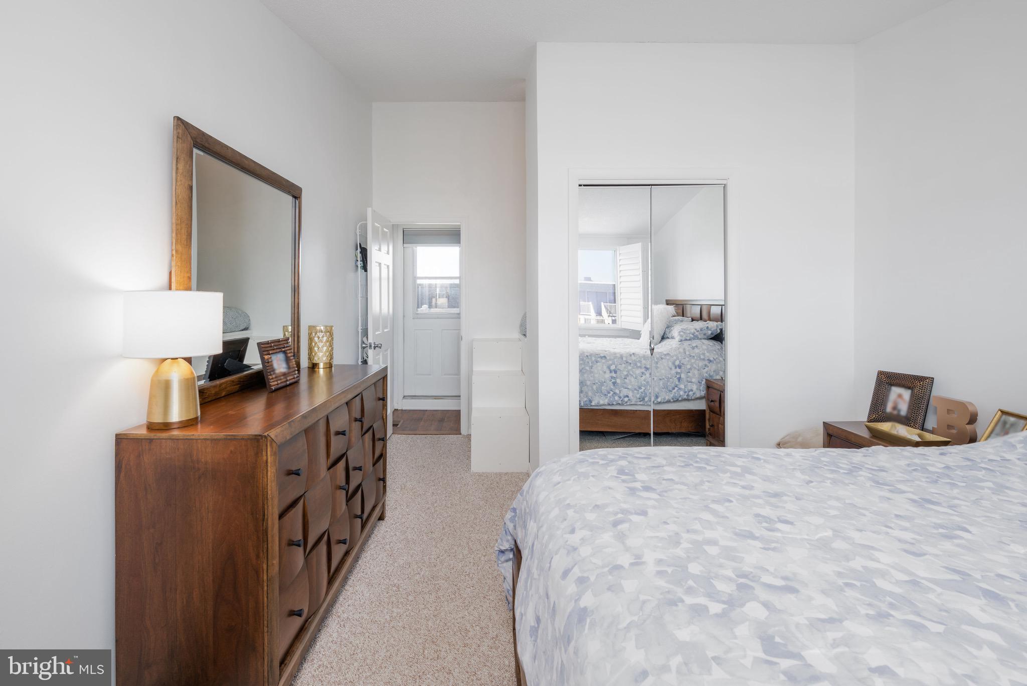 720 Rusty Anchor Road, Unit 41C Ocean City, MD 21842 - Photo 20 of 32 a bedroom with double bed and a mirror