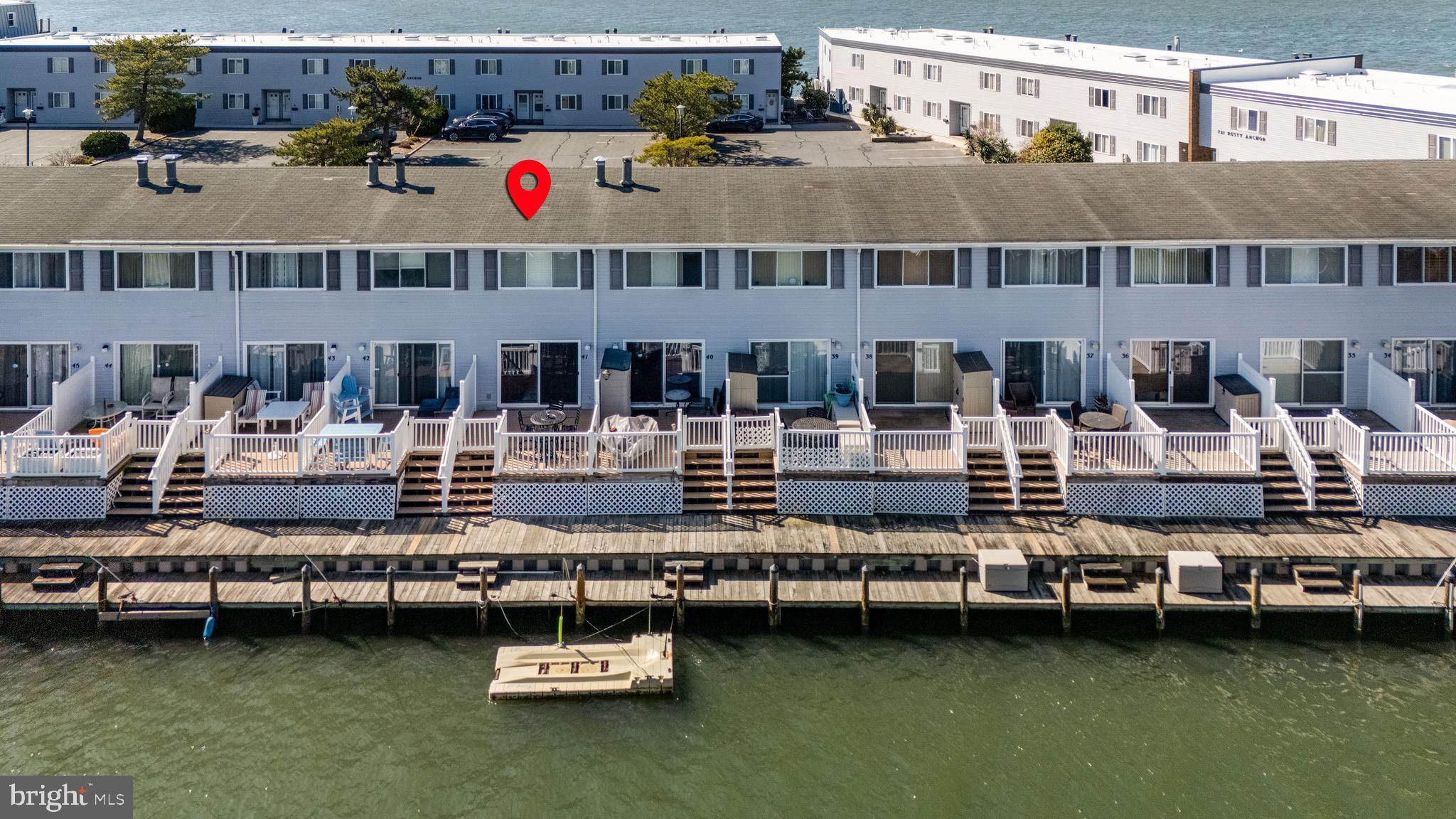 720 Rusty Anchor Road, Unit 41C Ocean City, MD 21842 - Photo 2 of 32 a view of building with lake and trees