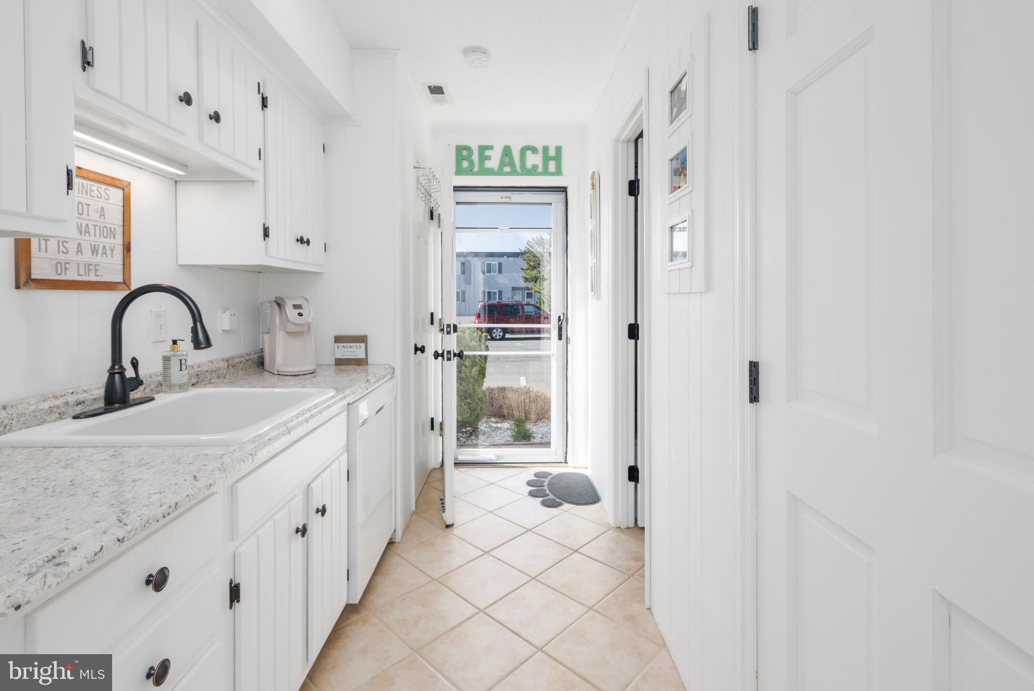 720 Rusty Anchor Road, Unit 41C Ocean City, MD 21842 - Photo 4 of 32 a bathroom with a double vanity sink mirror and bathtub