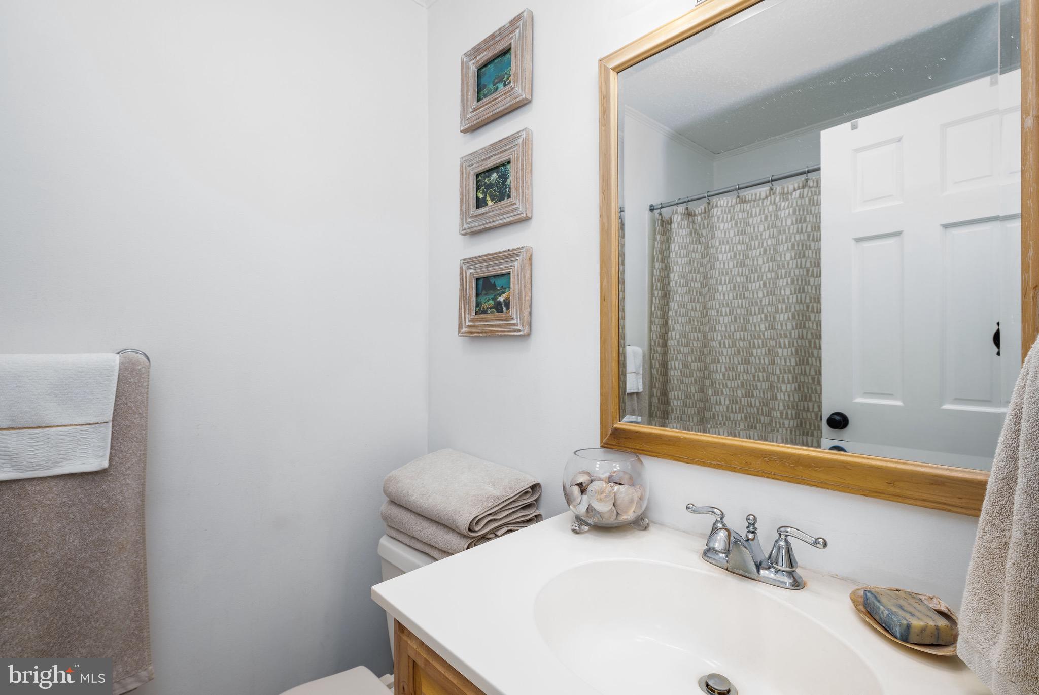 720 Rusty Anchor Road, Unit 41C Ocean City, MD 21842 - Photo 8 of 32 a bathroom with a sink and a mirror