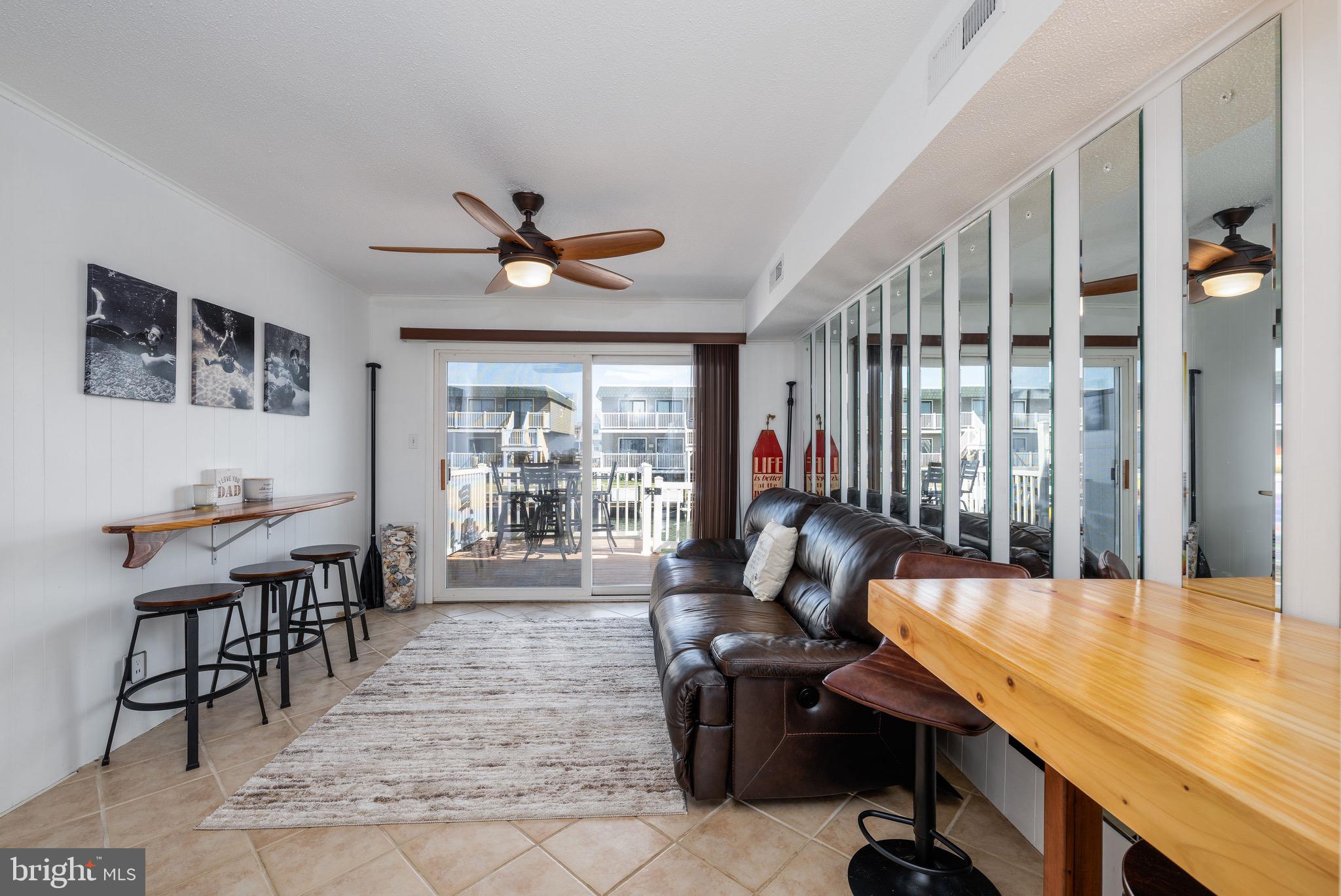 720 Rusty Anchor Road, Unit 41C Ocean City, MD 21842 - Photo 9 of 32 a living room with furniture a window and a flat screen tv