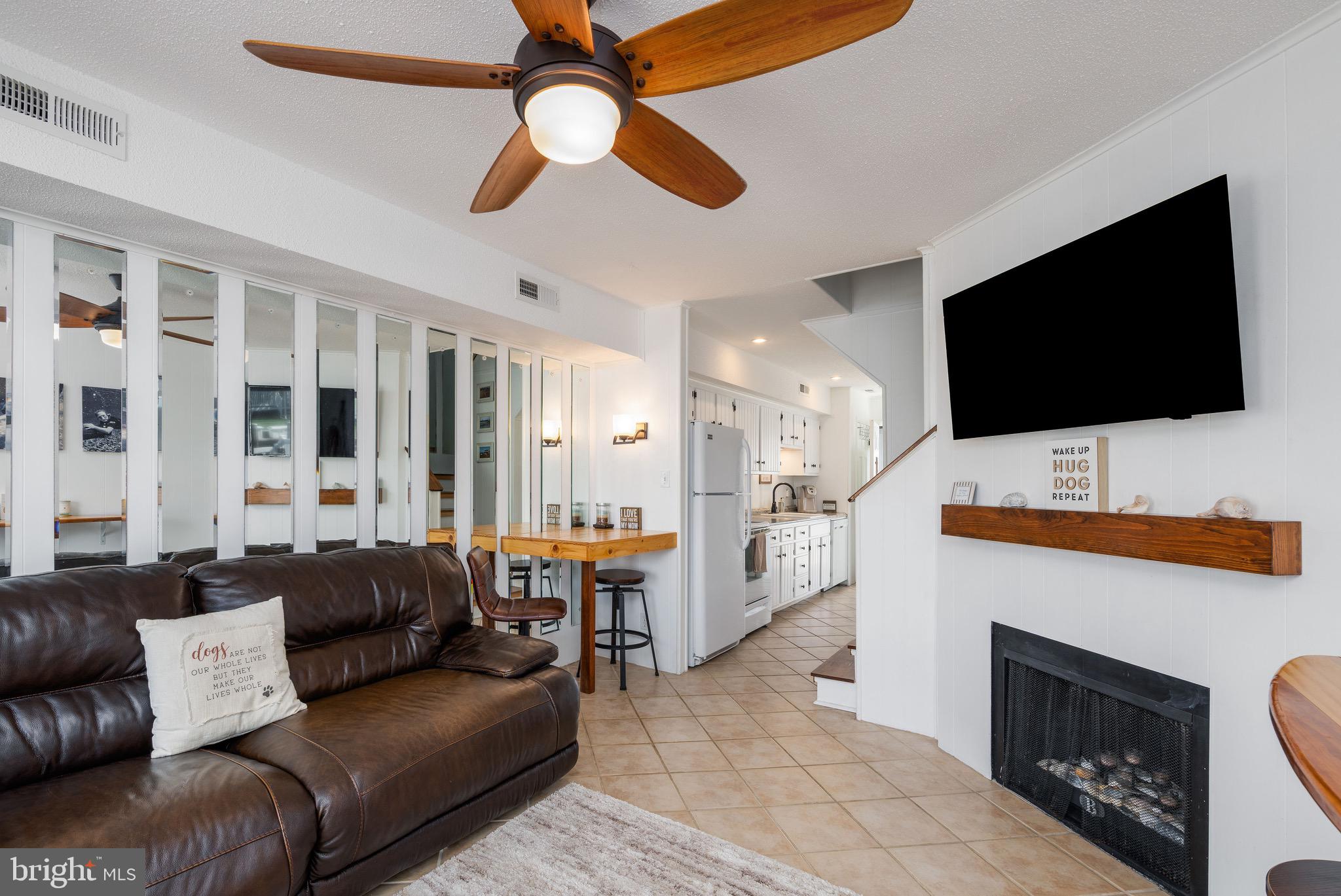 720 Rusty Anchor Road, Unit 41C Ocean City, MD 21842 - Photo 10 of 32 a living room with furniture and a flat screen tv