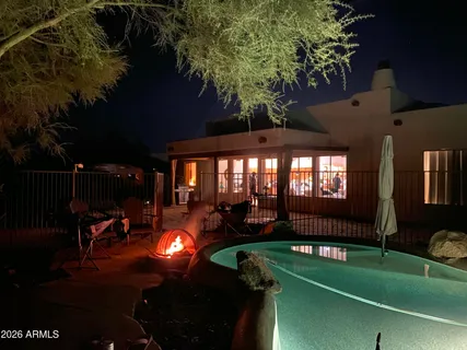 a backyard of a house with yard table and chairs