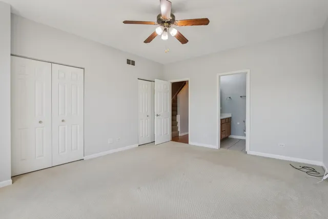 a view of an empty room with a ceiling fan