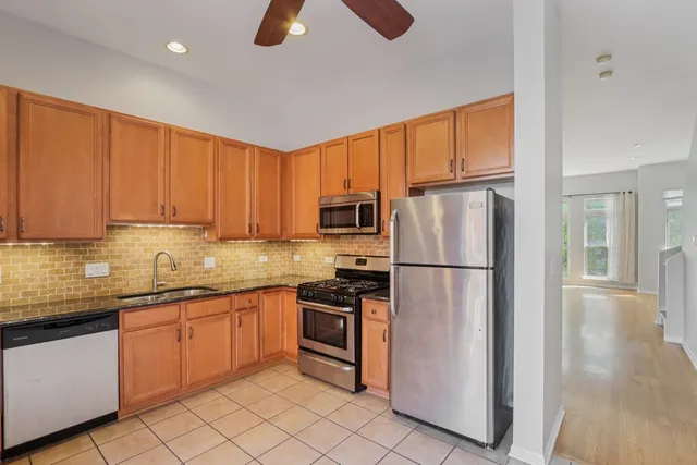 a kitchen with a sink stainless steel appliances and cabinets