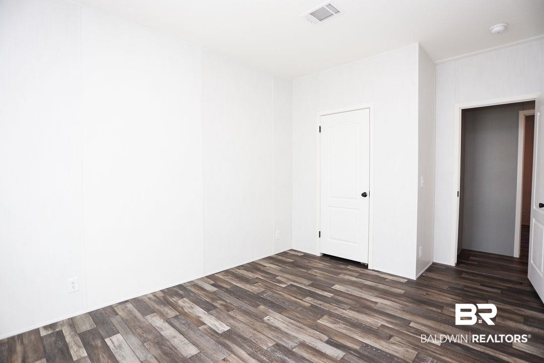 19180 Horseshoe Circle Seminole, AL 36574 - Photo 20 of 38 Unfurnished room featuring dark wood-style floors
