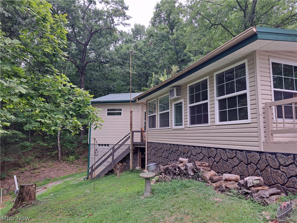 17875 Lashley Road, Unit 124 Senecaville, OH 43780 - Photo 4 of 45 View of side of property featuring a lawn