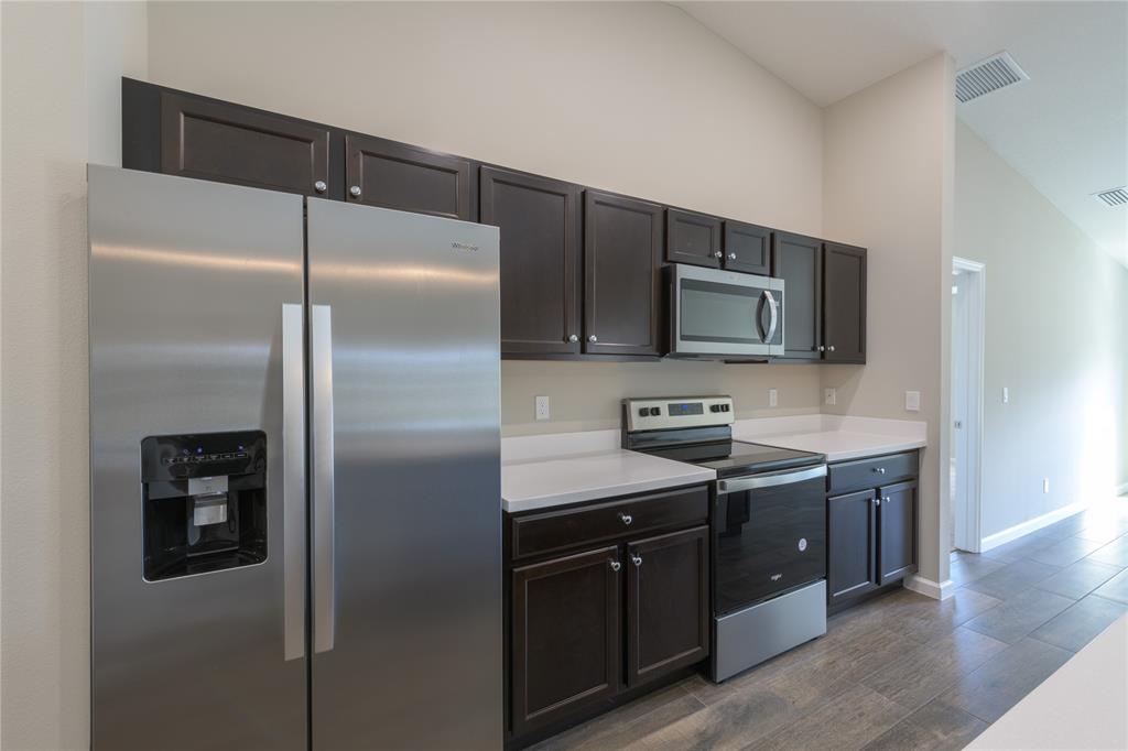 730 Southwest McCall Road Port St. Lucie, FL 34953 - Photo 11 of 28 a kitchen with a refrigerator and a sink