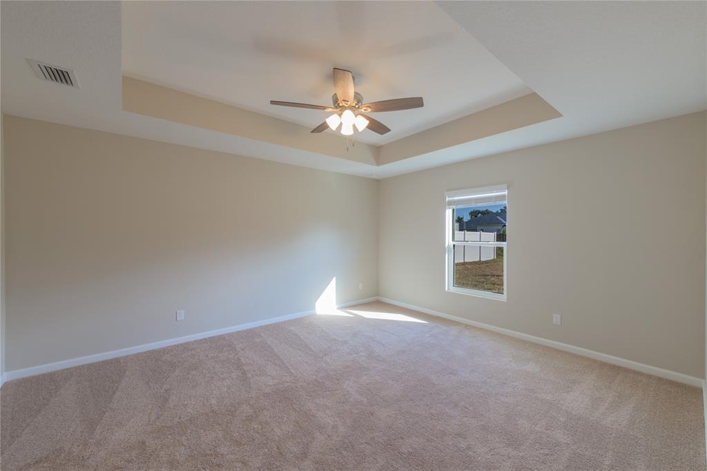 730 Southwest McCall Road Port St. Lucie, FL 34953 - Photo 12 of 28 an empty room with a window and ceiling fan