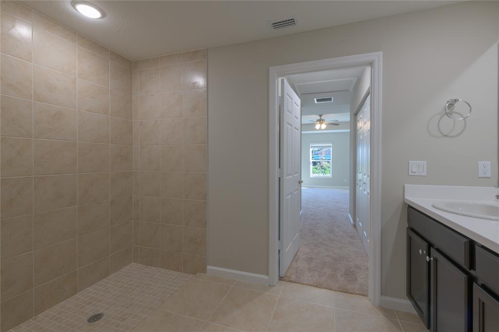 730 Southwest McCall Road Port St. Lucie, FL 34953 - Photo 15 of 28 a bathroom with a granite countertop sink a vanity and a mirror