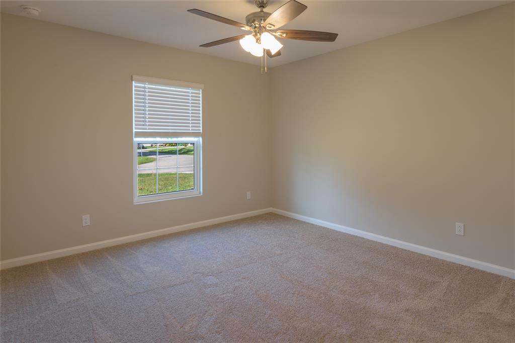 730 Southwest McCall Road Port St. Lucie, FL 34953 - Photo 20 of 28 an empty room with a window and a fan