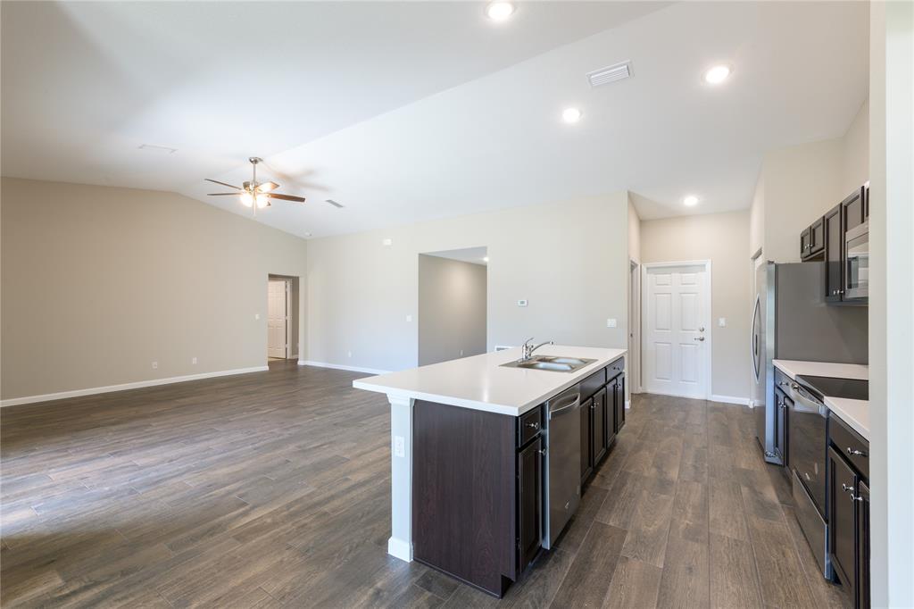 730 Southwest McCall Road Port St. Lucie, FL 34953 - Photo 5 of 28 a kitchen with a sink appliances and wooden floor