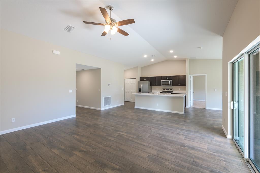 730 Southwest McCall Road Port St. Lucie, FL 34953 - Photo 6 of 28 a view of kitchen with wooden floor and window
