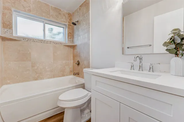 a bathroom with a sink toilet and bathtub