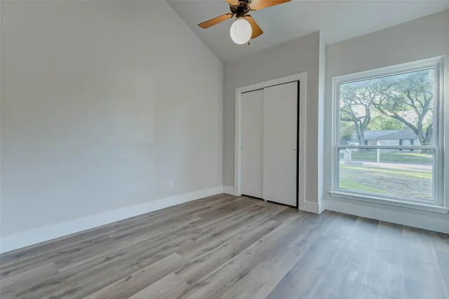 a view of wooden floor and windows in a room