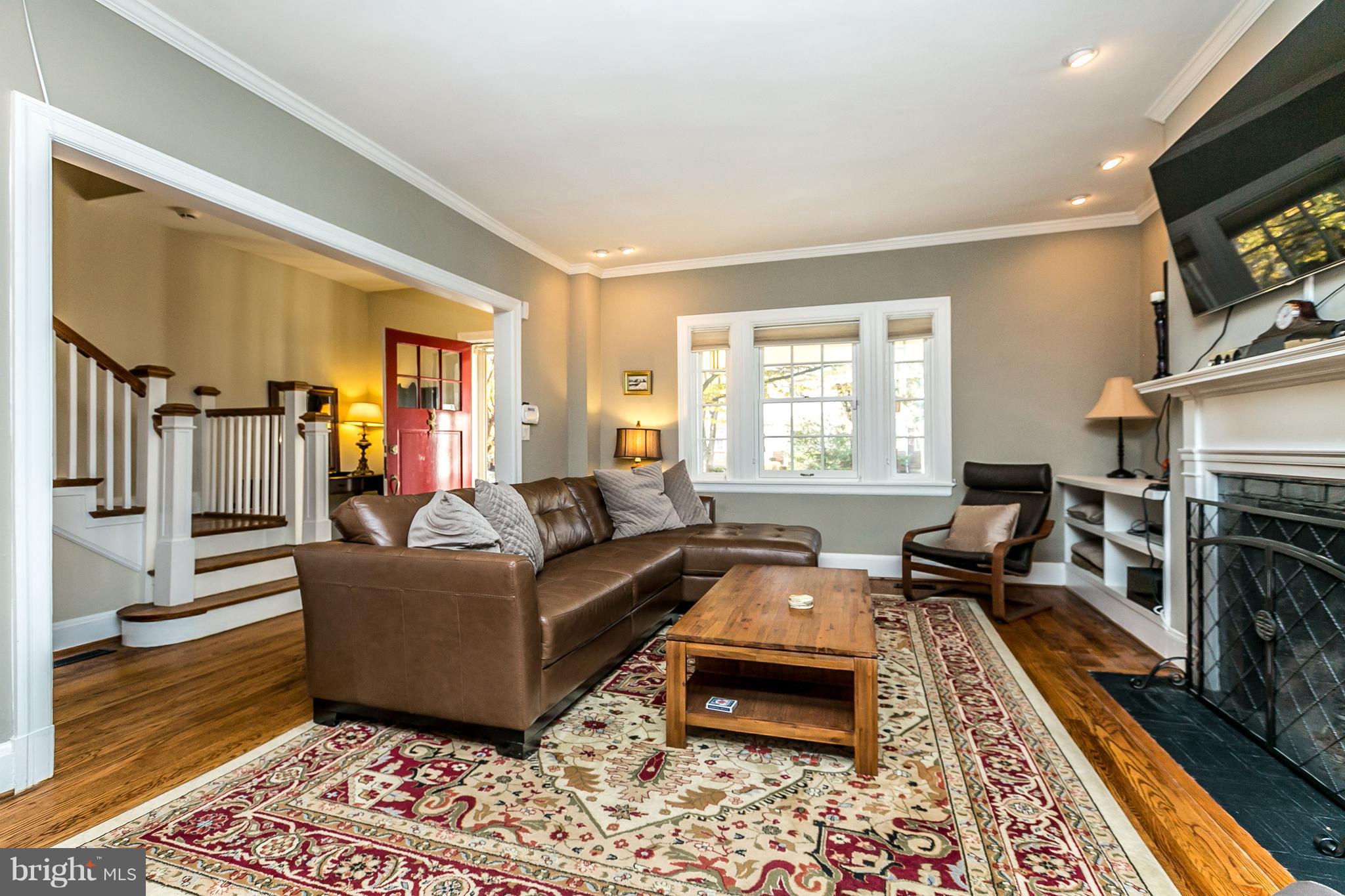 4223 Wickford Road Baltimore, MD 21210 - Photo 3 of 36 a living room with furniture flat screen tv and a fireplace