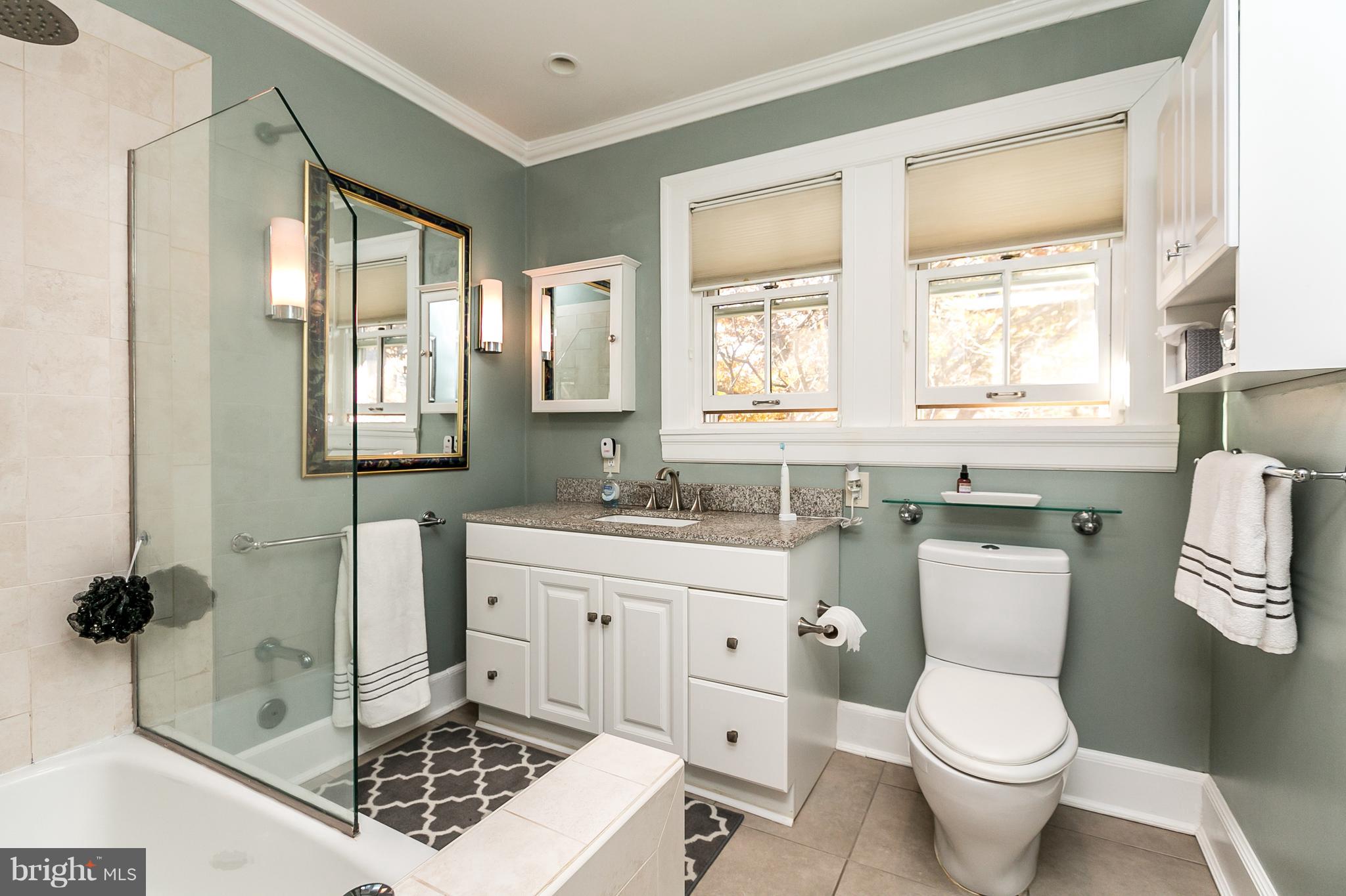 4223 Wickford Road Baltimore, MD 21210 - Photo 22 of 36 a bathroom with a sink toilet a mirror and tub